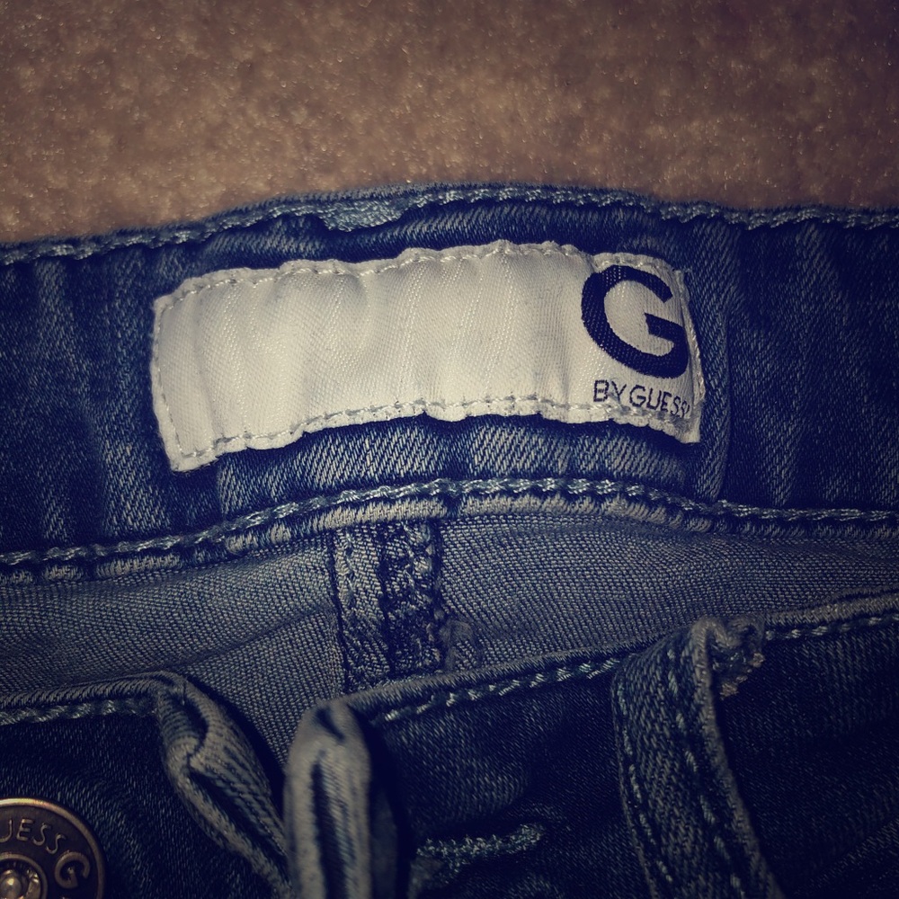 Guess blue denim jeans w/ a few rips